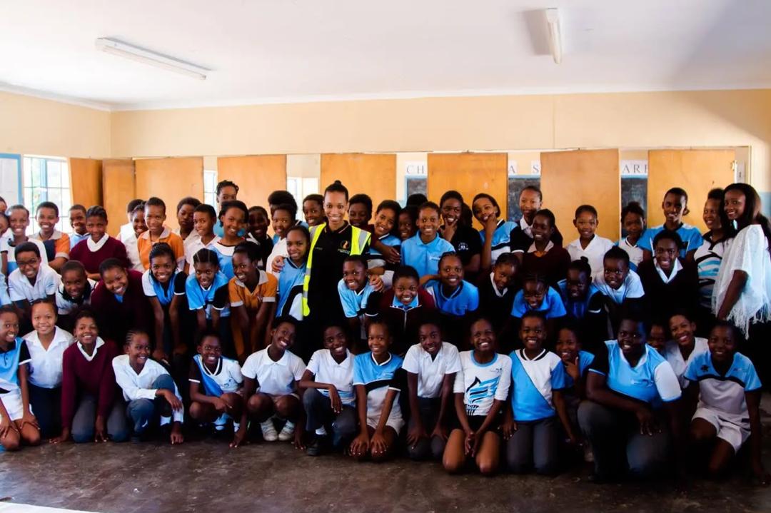 Schoolchildren learning about clean energy from a Pula Wealth Group representative